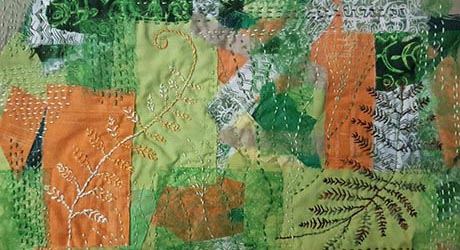 Hand stitched work depicting fern-like forms against a patchwork background of orange and green fabrics