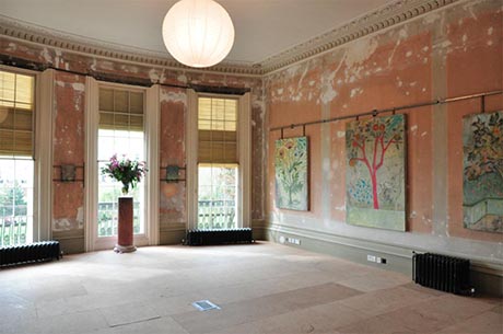 View of drawing room showing exhibition of Viva magazine covers.