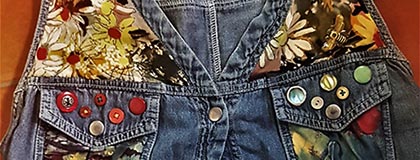Photo of denim top decorated with buttons and fabric patches