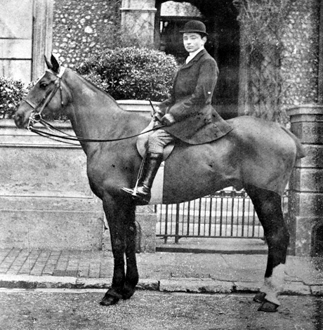 monochrome image of a man sitting on a horse