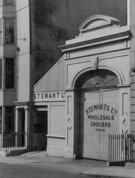 monochrome photo of the entrance with stewarts sign above