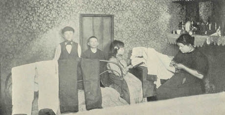 1900s black and white photo of a family of tailors