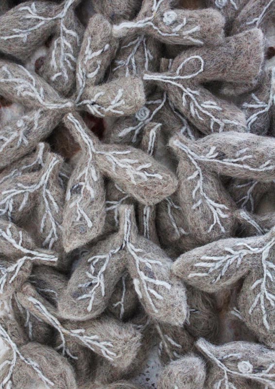 Artwork of greyish brown felt pieces embroidered with white thread and designed to represent the alveoli, or air sacs of the lungs. 