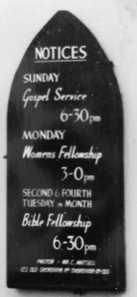 monochrome photo of a sign outside a buidling