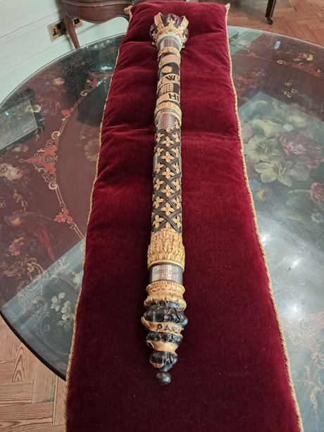 A colour photo showing the full length of a silver staff