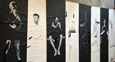 Photograph of eight tall, narrow images of people. They are drawn alternately, white on black and black on white.