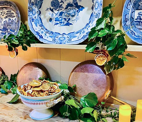 Photo of dried fruit in a bowl with blue and white plates on a dresser.