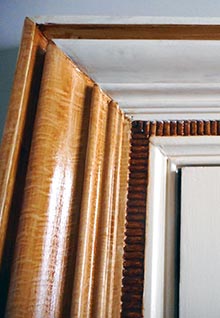 Wood graining being applied to a door architrave