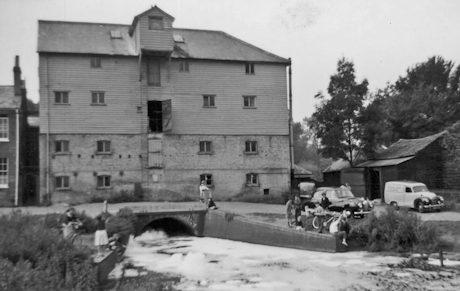A monochrome photo of a large wooden building
