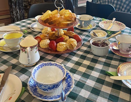A table laden with tea and cakes